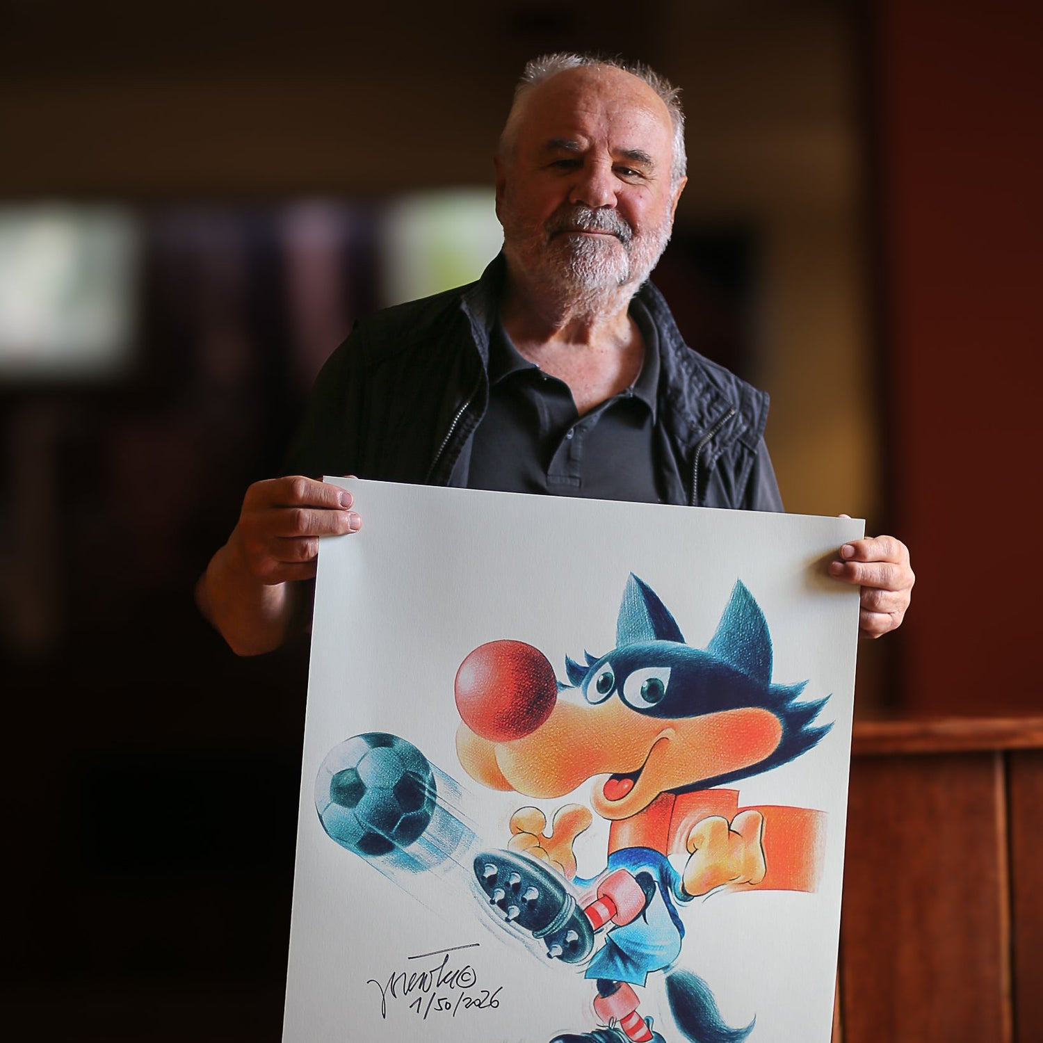 Jože Trobec holding poster with Vučko footballer