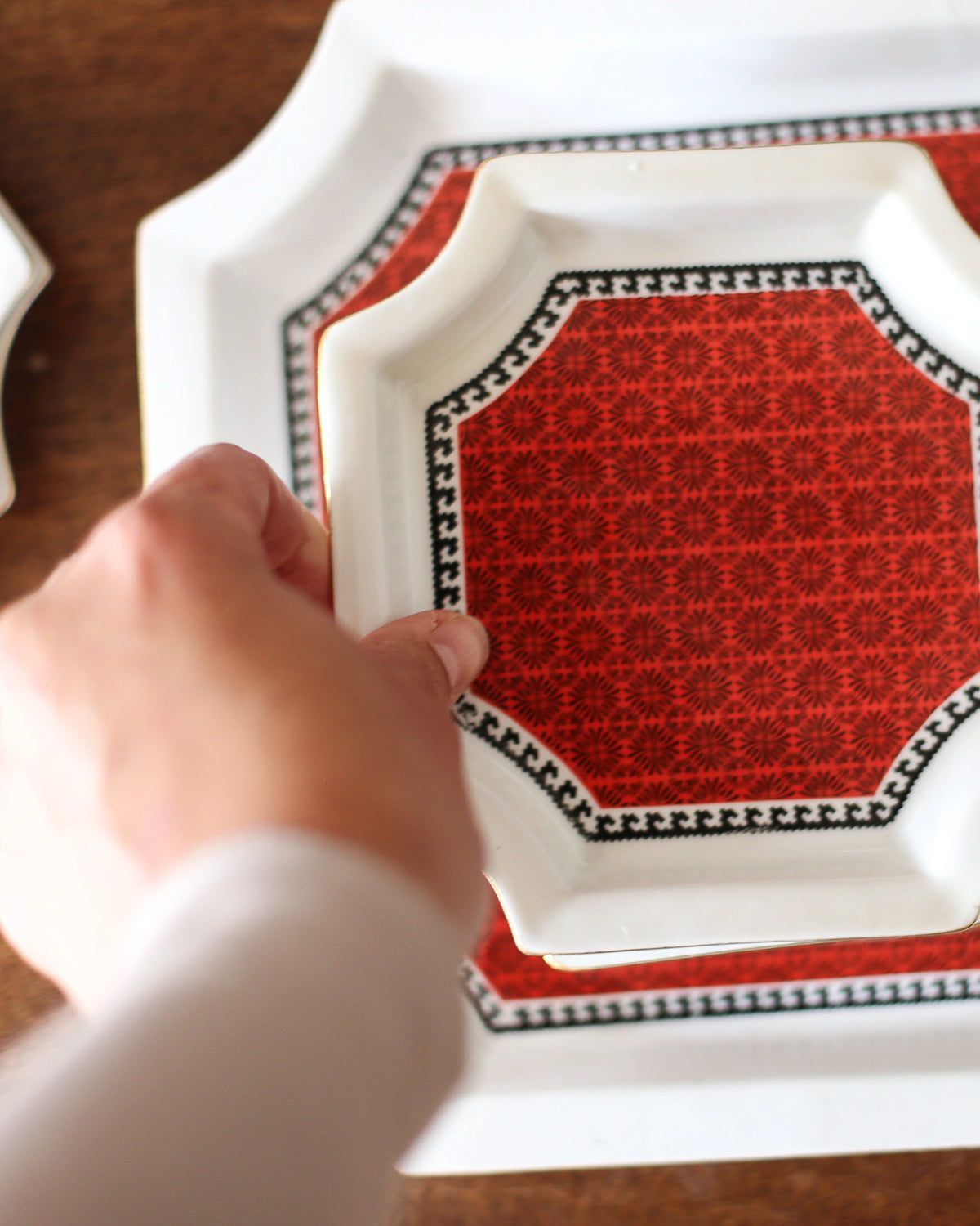 Close-up of red patterned FP Zaječar small plate and serving plate