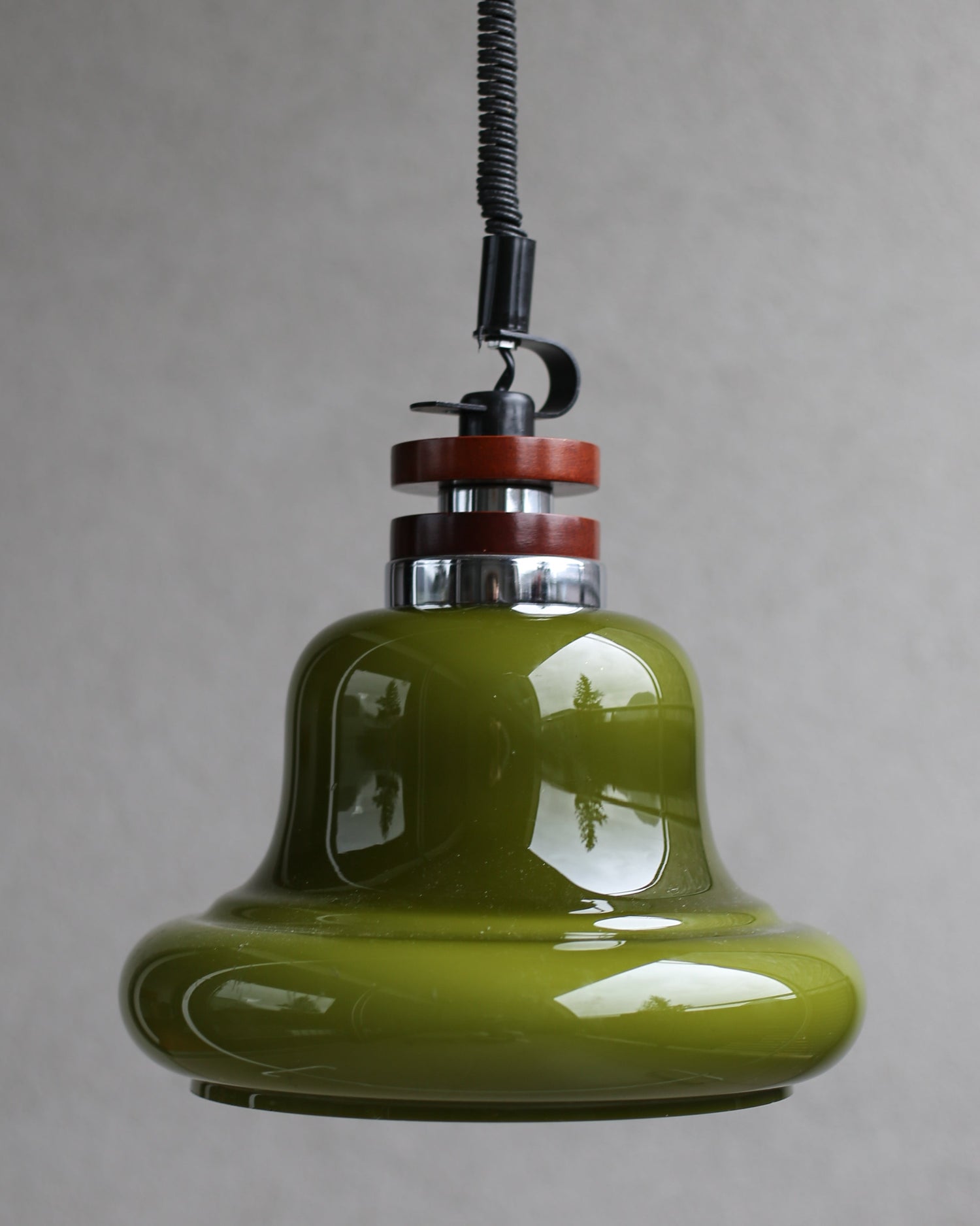 Green pendant light with a gray background