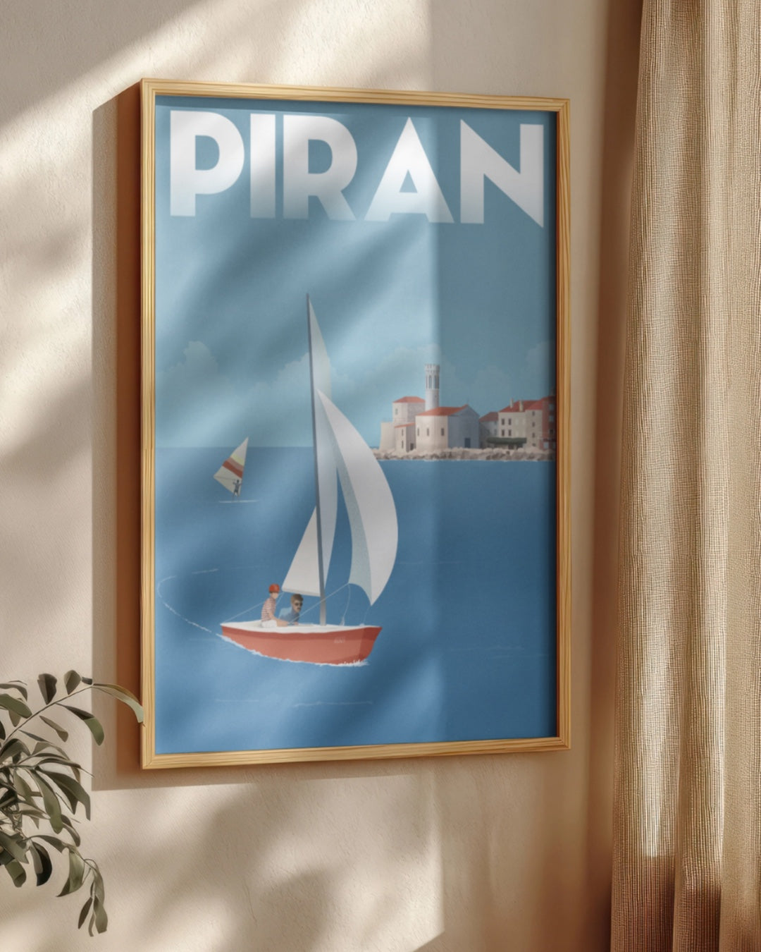 Framed artwork with 'PIRAN' and a sailboat design on a blue background.